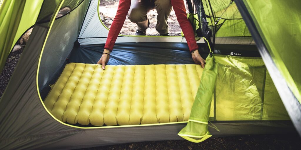 To make sure you get a good night's sleep while camping, you may consider getting a sleeping pad and putting it into your tent. A good sleeping pad should provide ample padding for a great night’s sleep, and also be warm enough to be used from spring through fall. There are so many different sleeping pads to choose from, depending on your sleep style, type of camping, or body shape. Examples include closed-cell foam pads, self-inflating sleeping pads, air mattresses, and inflatable insulated sleeping pads.