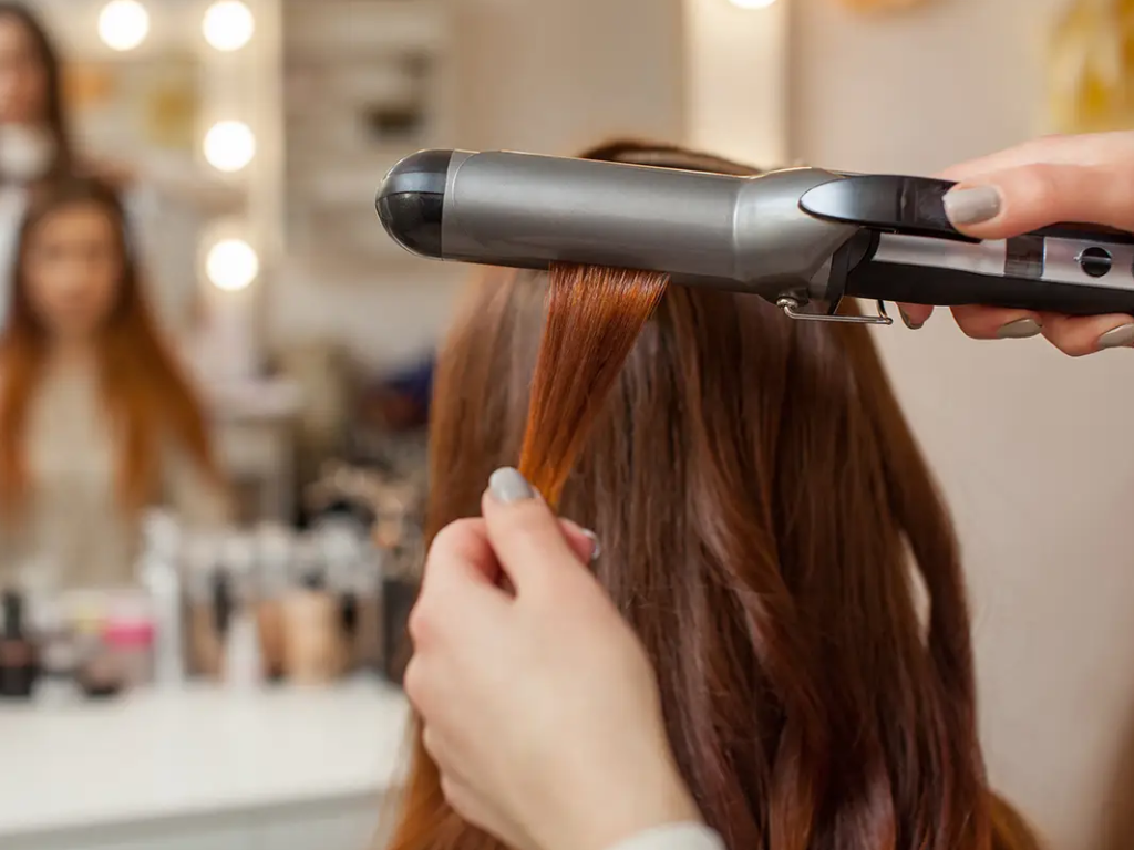 Making hairstyle with curling iron