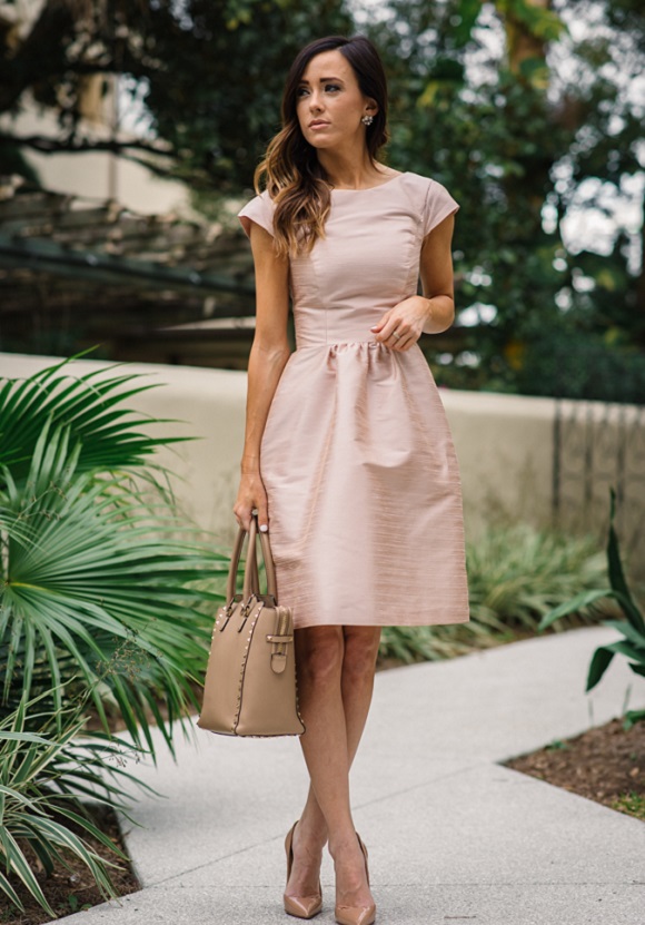 picture of a woman in beige cocktail dress outside 