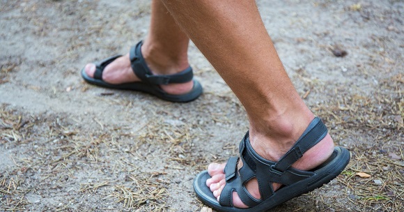 picture of a men walking in open toe sandals