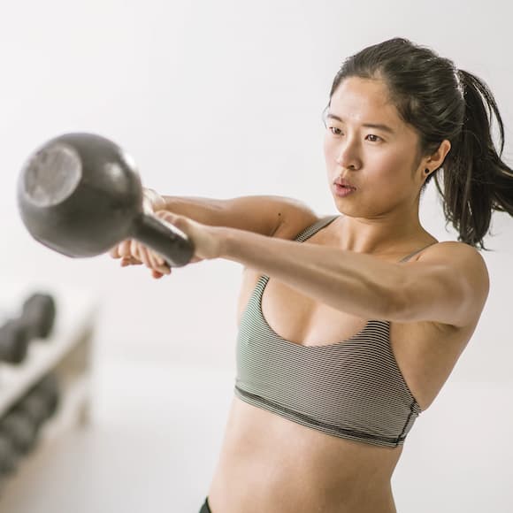 Girl working out with a kettlebell