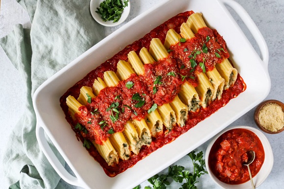 cooked vegan cannelloni dish with tomato sauce 