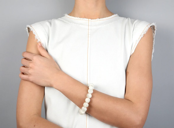 picture of woman wearing white dress and white bracelet 
