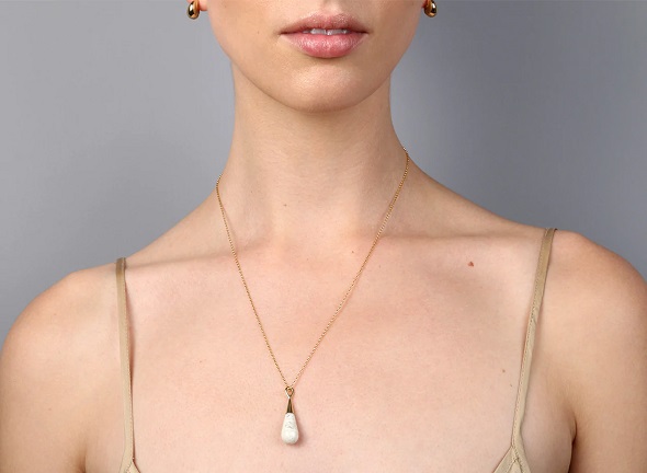 picture of woman wearing earings and chain necklace resin jewellery designer pieces 